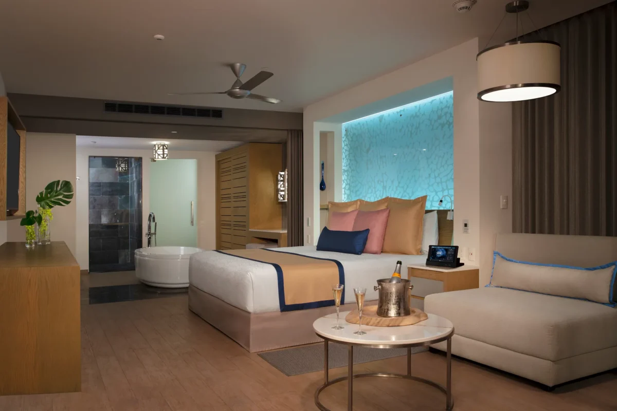 Preferred Club Master Suite Ocean View bedroom with king bed and spa-style bathroom at Secrets Riviera Cancun.