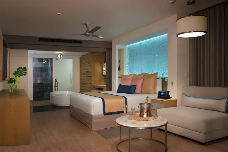 Preferred Club Master Suite Ocean View bedroom with king bed and spa-style bathroom at Secrets Riviera Cancun.
