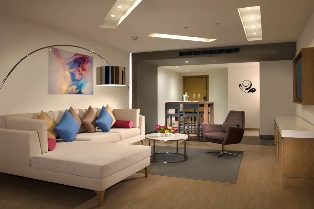 Preferred Club Master Suite Swim Out Ocean Front living room at Secrets Riviera Cancun with modern lounge seating and bar area.