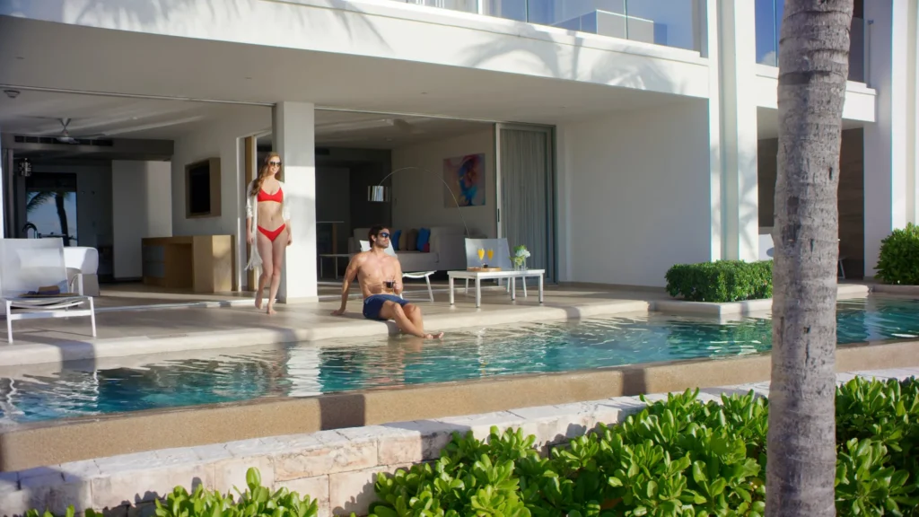 Couple enjoying private terrace with swim-up pool at Preferred Club Master Suite Swim Out Ocean Front in Riviera Cancun.