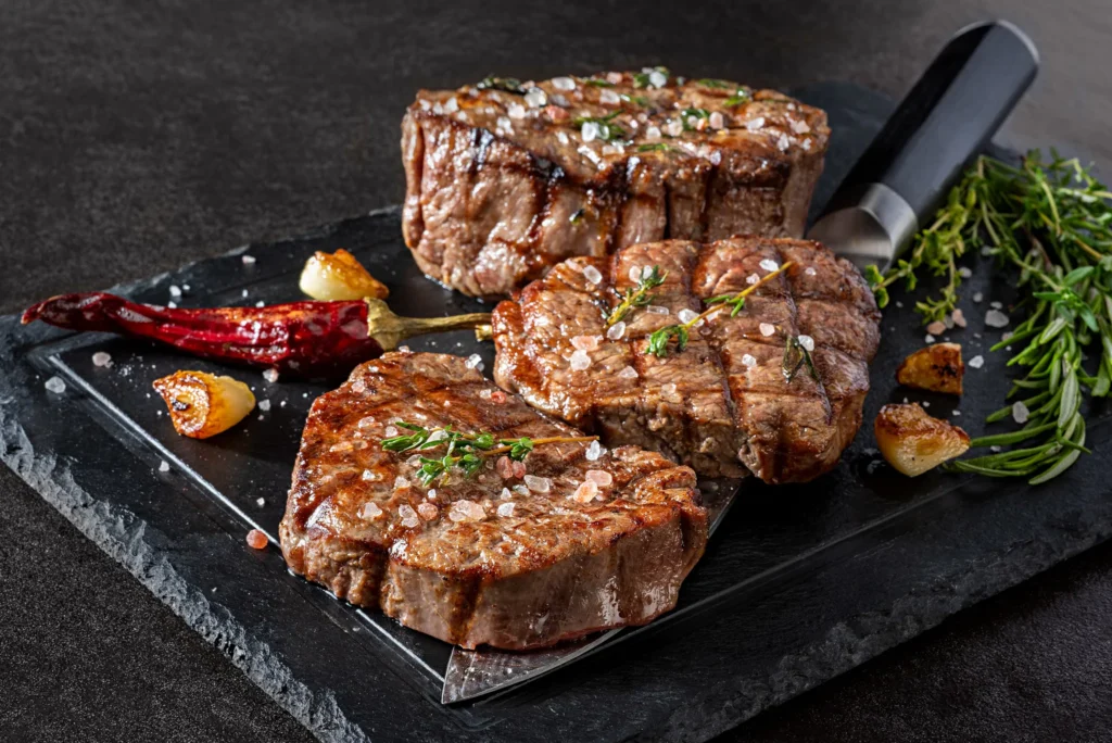 The Strip Grill at Secrets Riviera Cancun featuring premium grilled steaks with sea salt, herbs, and Caribbean Sea views.