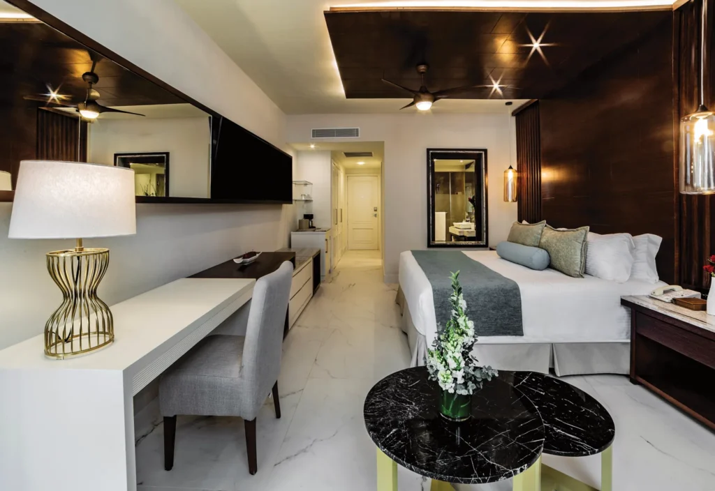 Junior Suite Partial Ocean View with king bed and workspace at Secrets Royal Beach Punta Cana.