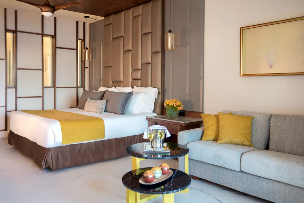 Preferred Club Junior Suite Partial Ocean View with king bed and seating area at Secrets Royal Beach Punta Cana.