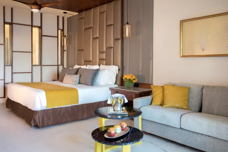 Preferred Club Junior Suite Partial Ocean View with king bed and seating area at Secrets Royal Beach Punta Cana.