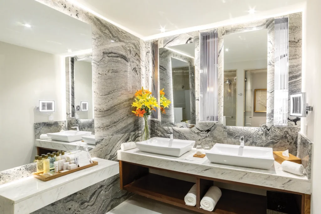 Preferred Club Junior Suite Tropical View marble bathroom with double sinks at Secrets Royal Beach Punta Cana.