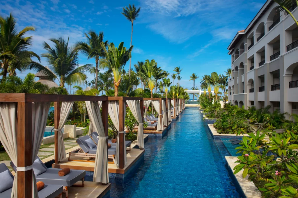 Scenic lazy river-style pool with private cabanas at Secrets Royal Beach Punta Cana.