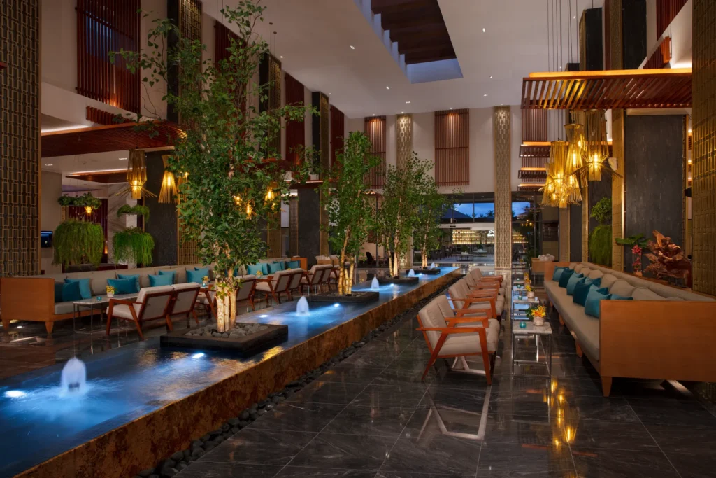 Elegant open-air lobby with water features and lounge seating at Secrets Royal Beach Punta Cana.