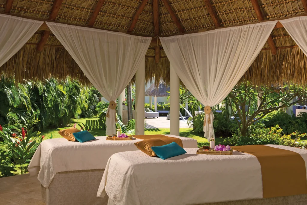 Outdoor massage cabin with tropical garden views at Secrets Royal Beach Punta Cana spa.