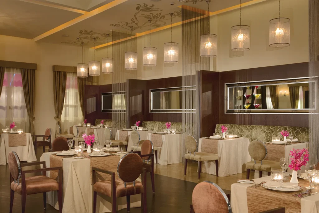 Bordeaux French restaurant at Secrets St. James Montego Bay featuring an elegant dining room with soft lighting, modern décor, and intimate table settings.