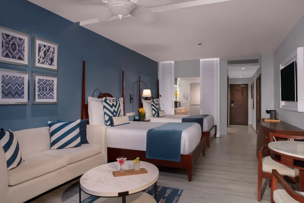 Junior Suite Garden View with two queen beds and sitting area at Secrets St. James Montego Bay.