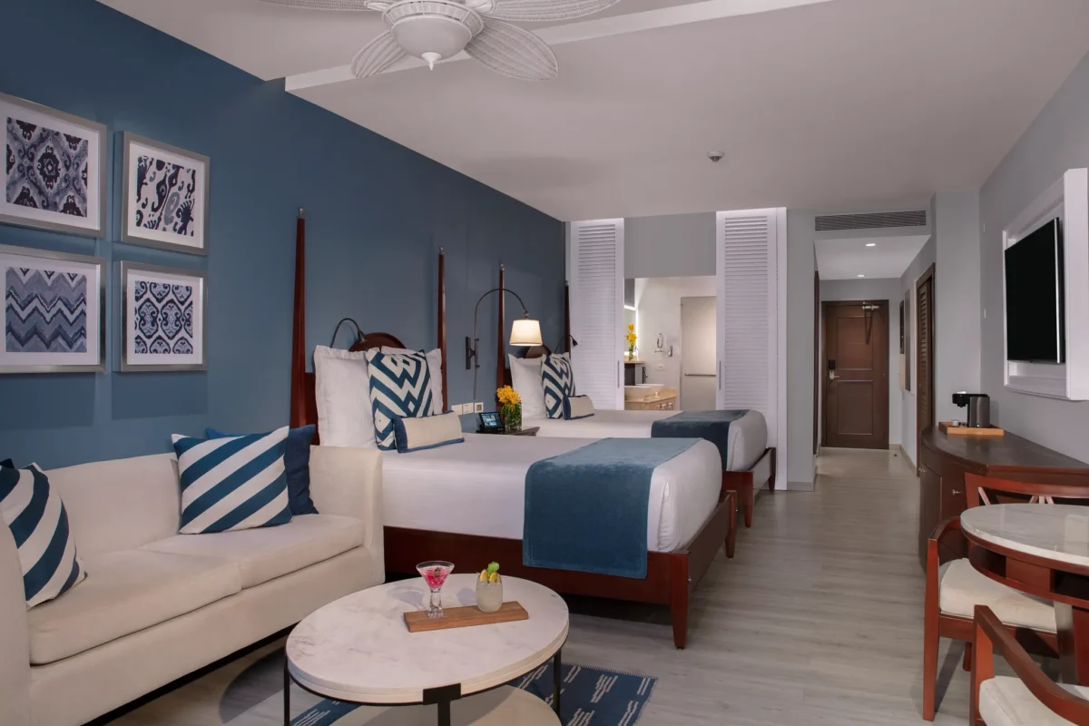 Junior Suite Ocean View with two queen beds, sitting area, and modern décor at Secrets St. James Montego Bay.