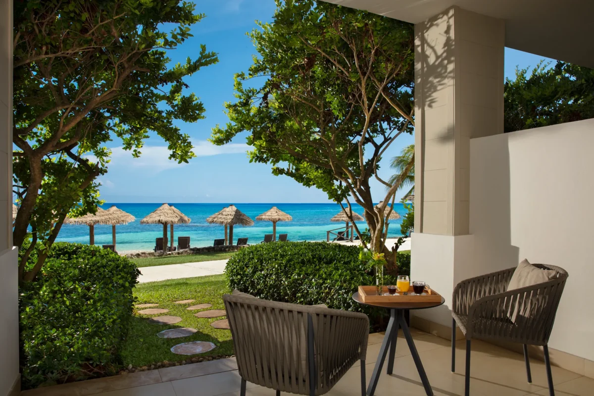 Preferred Club Premium Junior Suite Beachfront terrace with ocean view and seating area at Secrets St. James Montego Bay.