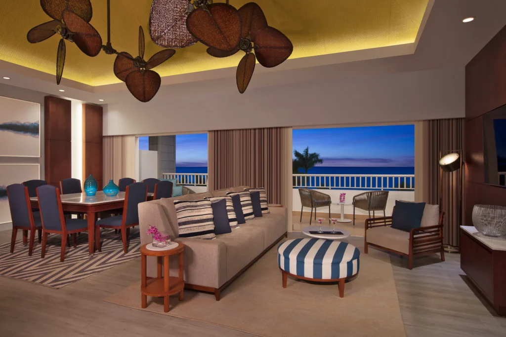 Preferred Club Presidential Suite Ocean Front living room with dining area and ocean view at Secrets St. James Montego Bay.