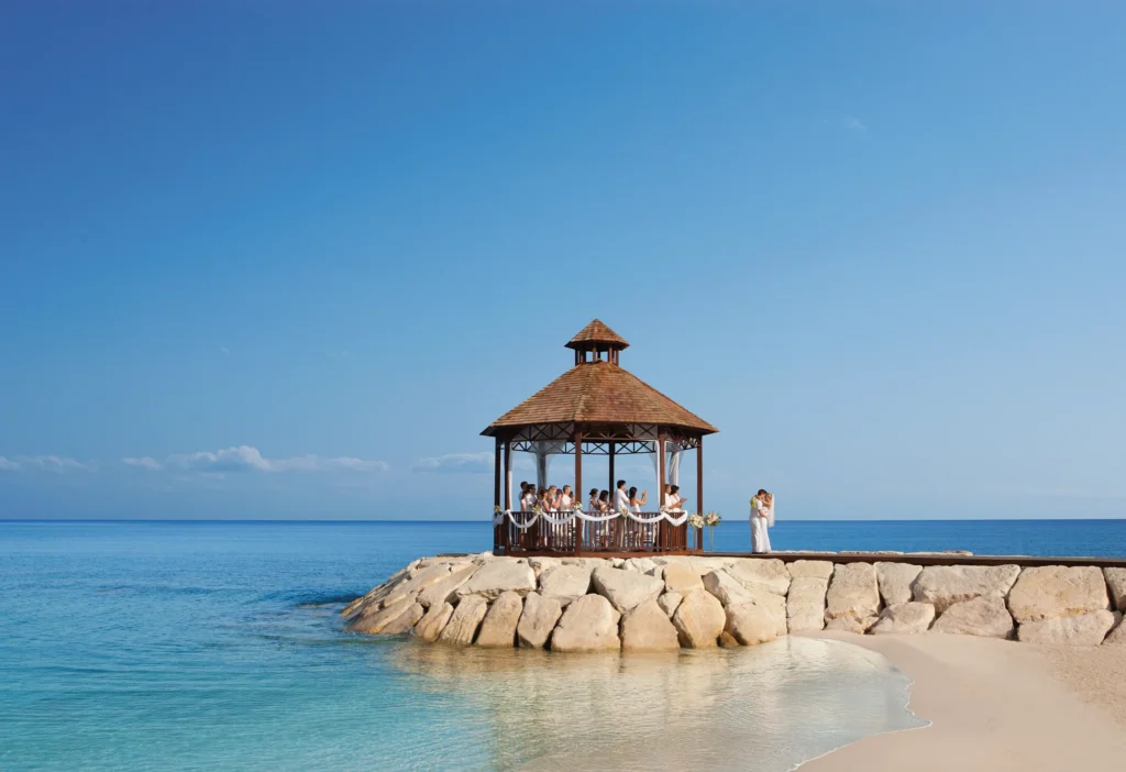Beachside gazebo wedding setup with turquoise water and white sand at Secrets St. James Montego Bay