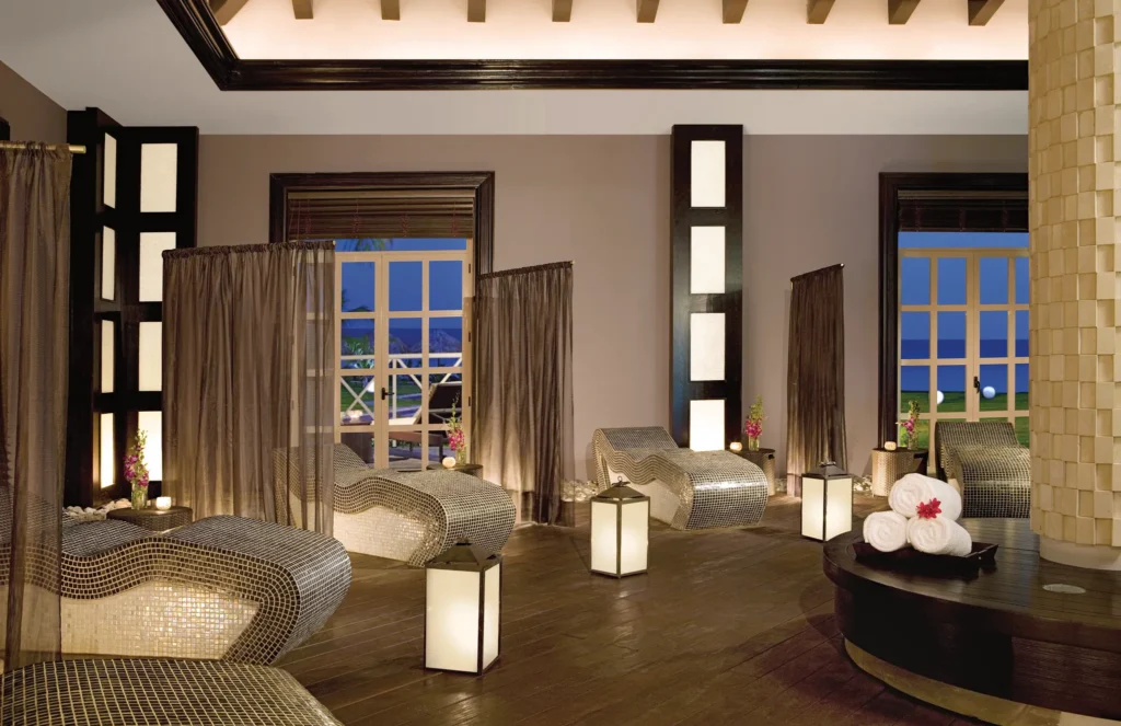 Indoor spa relaxation lounge with cushioned chairs and ambient lighting at Secrets St. James Montego Bay.