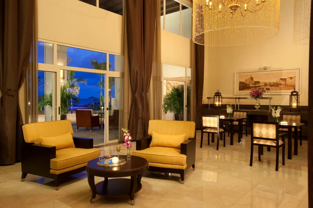 Elegant lounge area with modern furnishings and ocean views inside a suite at Secrets St. James Montego Bay.