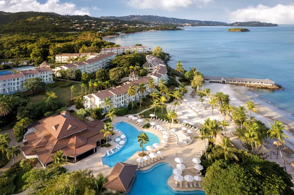 Aerial view of Secrets St. Lucia Resort & Spa showing beach, pool, and tropical landscape.