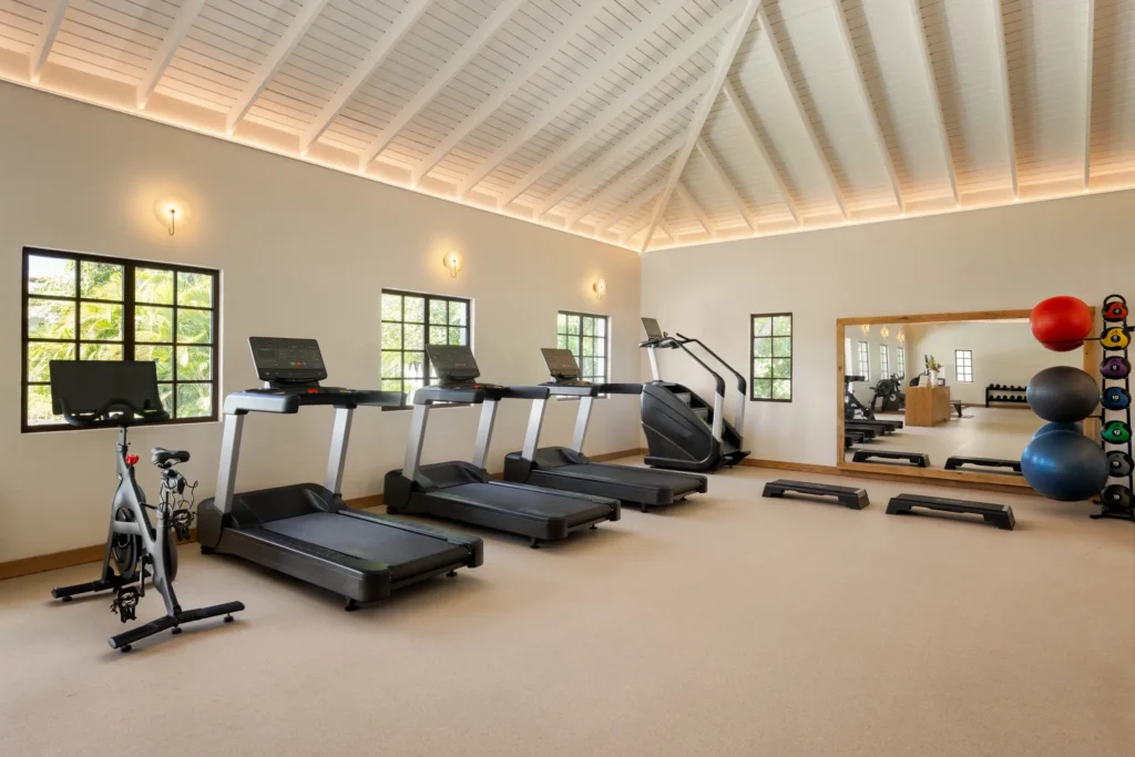 Indoor fitness center with treadmills and workout equipment at Secrets St. Lucia Resort & Spa.