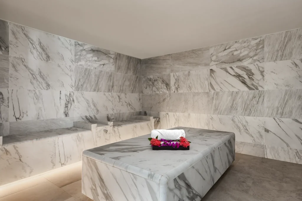 Marble hammam steam room at Secrets St. Lucia Resort & Spa, featuring heated stone seating for a luxurious spa ritual.