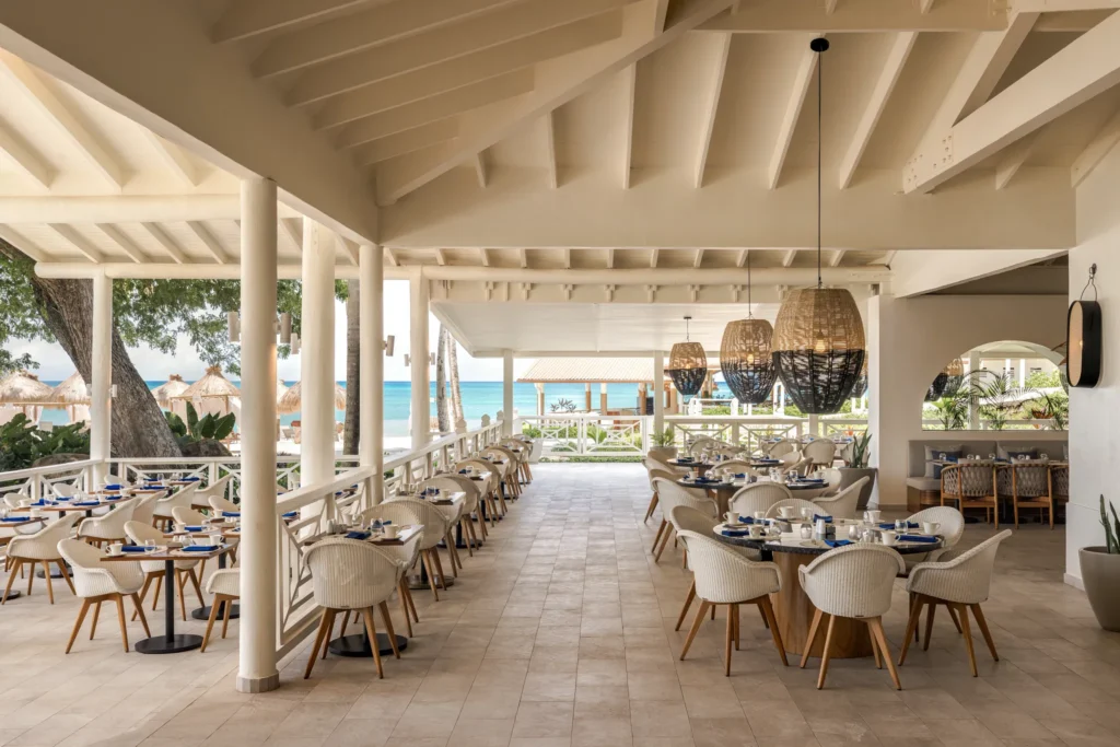 Market Café at Secrets St. Lucia Resort & Spa featuring an open-air buffet restaurant with tropical garden views and a variety of international dishes.