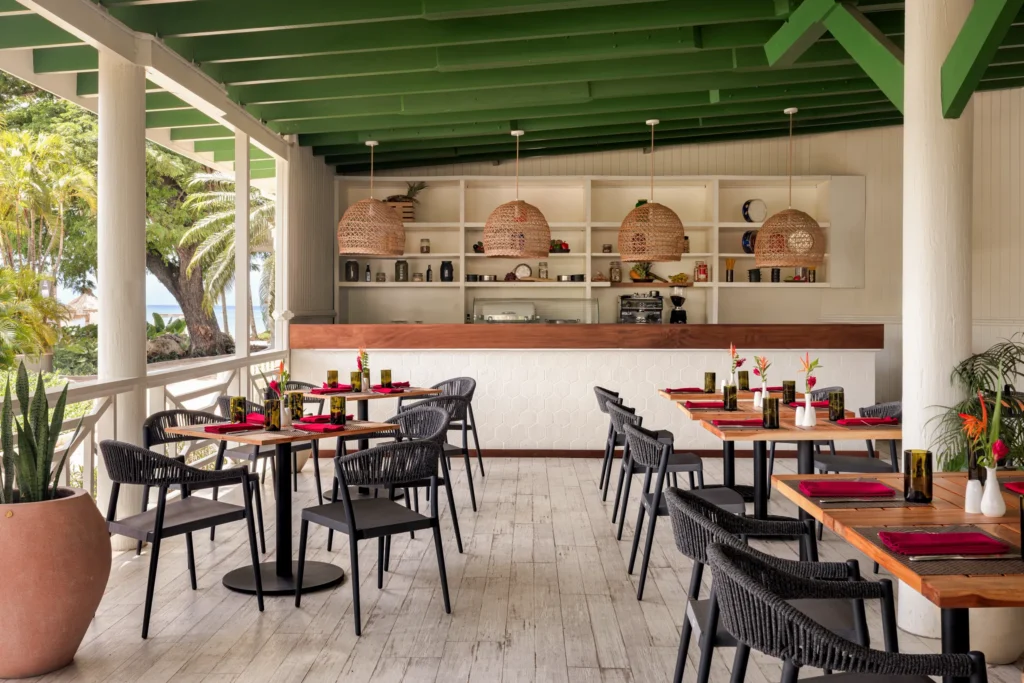Open-air beachfront restaurant with ocean views at Secrets St. Lucia Resort & Spa, featuring tropical dining and elegant seating.