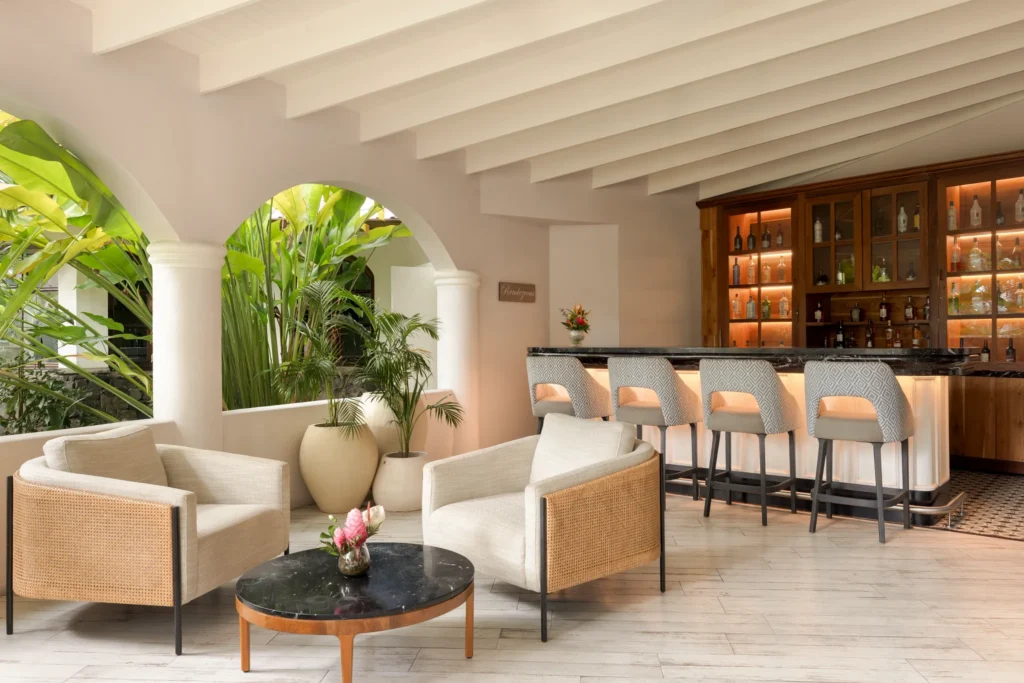 Rendezvous Lobby Bar at Secrets St. Lucia Resort & Spa featuring an elegant indoor lounge with stylish seating and handcrafted cocktails.