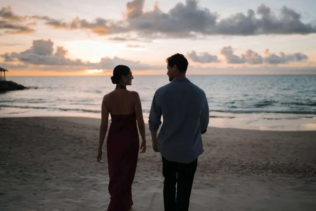 Couple walking along the beach at sunset at Secrets St. Lucia Resort & Spa.