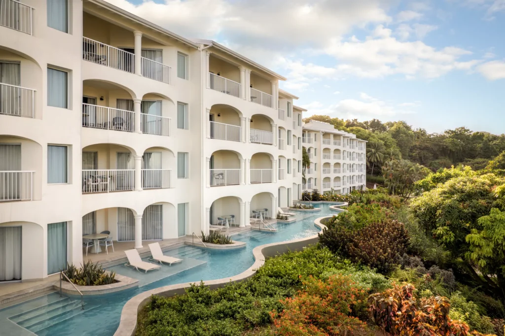 Swim-up suites with direct pool access at Secrets St. Lucia Resort & Spa surrounded by lush tropical gardens.