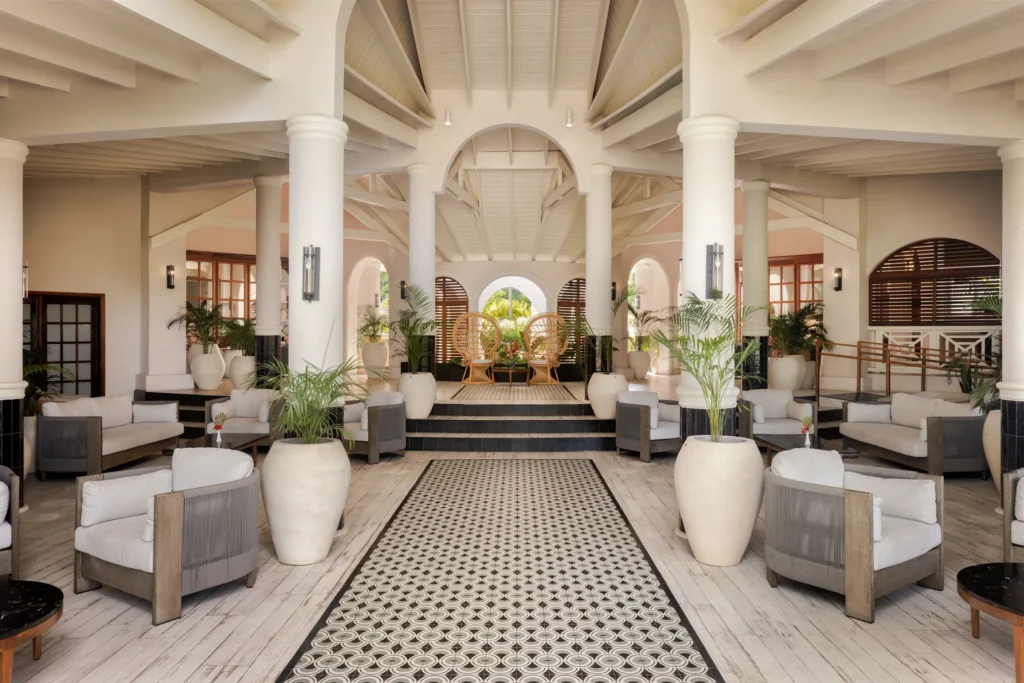 Elegant open-air lobby with seating and tropical decor at Secrets St. Lucia Resort & Spa.
