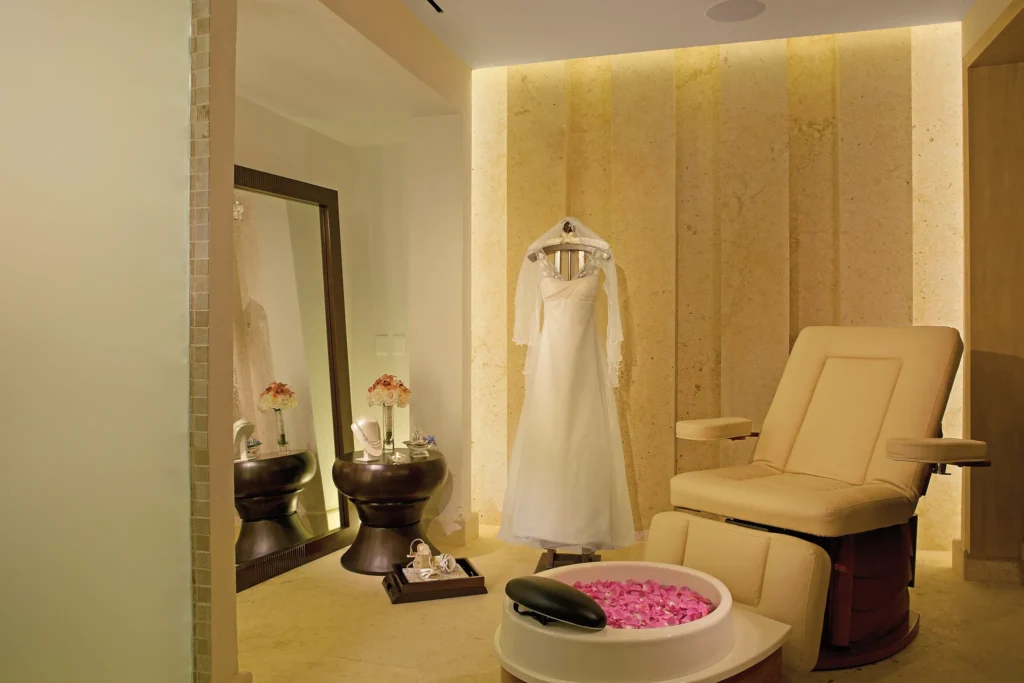 Bridal preparation room with wedding dress and spa chair at Secrets The Vine Cancun.