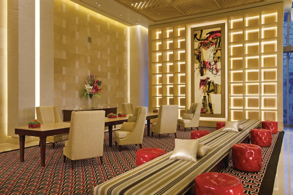 Elegant concierge lounge with modern seating and decorative lighting at Secrets The Vine Cancun.