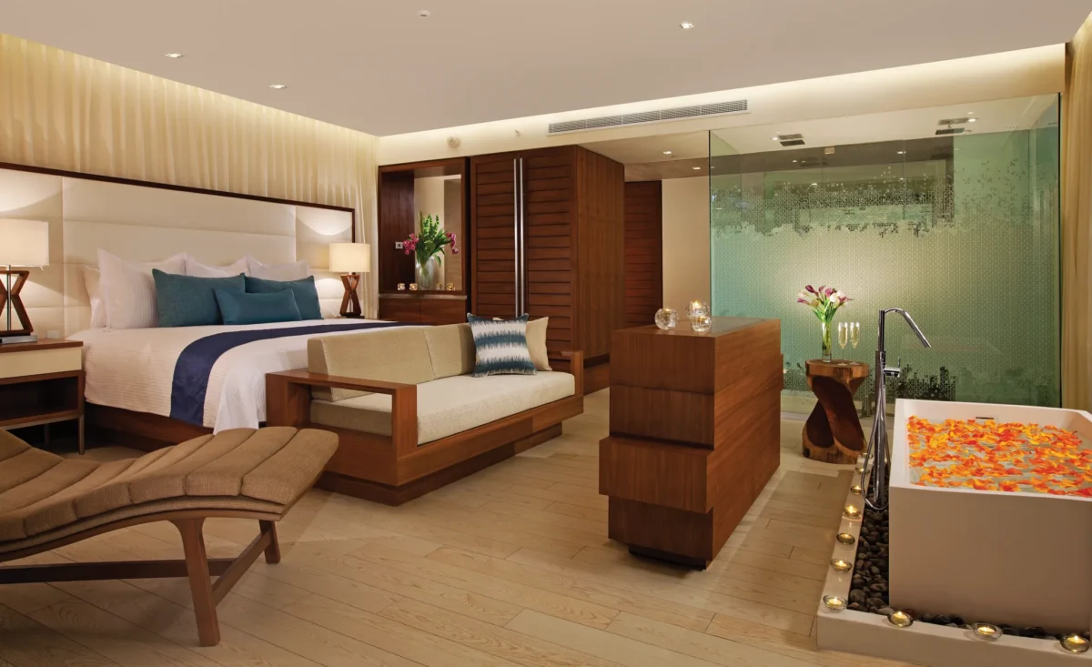 Honeymoon Suite Ocean Front with king bed, living area, and in-room soaking tub at Secrets The Vine Cancun.
