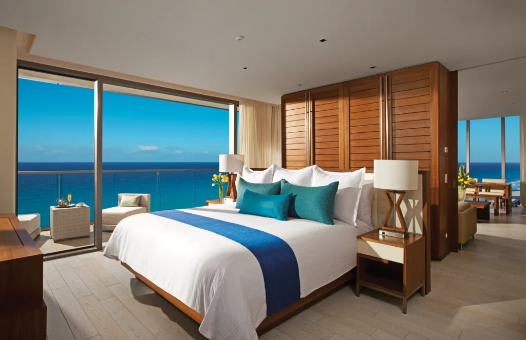 Master Suite Ocean Front bedroom with king bed and balcony overlooking the ocean at Secrets The Vine Cancun.