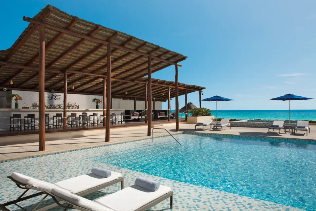 Sugar Reef Pool Bar at Secrets The Vine Cancun featuring a chic poolside bar with ocean views, cocktails, and a relaxed beach-casual atmosphere.