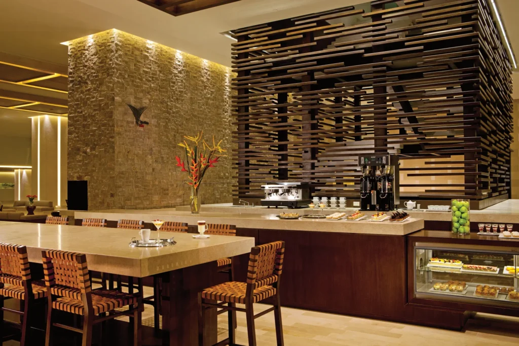 The Vine Bazaar Café at Secrets The Vine Cancun featuring a cozy coffee shop with pastries, premium coffee, and a relaxed lounge atmosphere.