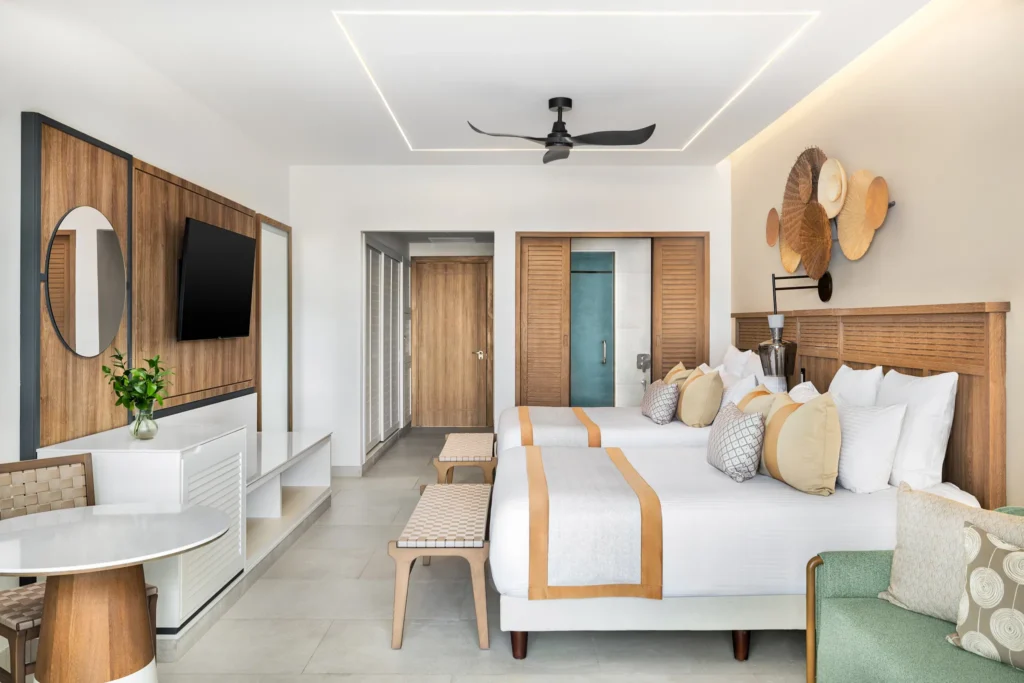 Junior Suite Pool View with two double beds and modern tropical décor at Secrets Tides Punta Cana resort.