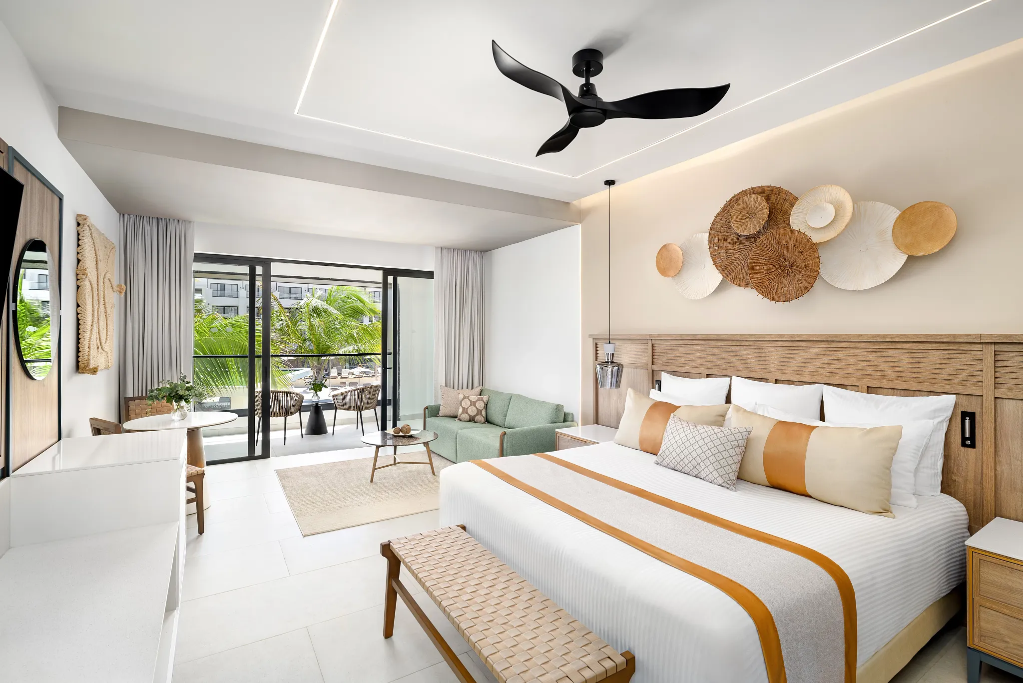 Junior Suite Pool View with king bed, seating area, and balcony overlooking the pool at Secrets Tides Punta Cana.