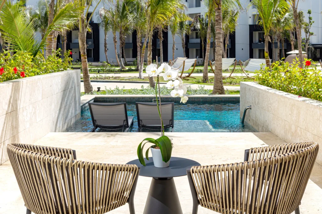 Junior Suite Swim-Out private terrace with chairs and direct pool access at Secrets Tides Punta Cana.