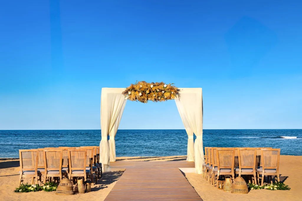 Oceanfront gazebo ceremony setup on the beach at Secrets Tides Punta Cana