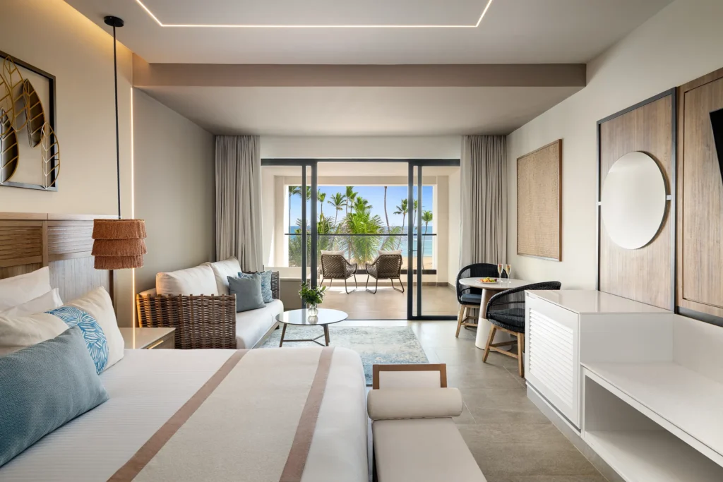 Preferred Club Junior Suite Ocean View with king bed and balcony overlooking the ocean at Secrets Tides Punta Cana.