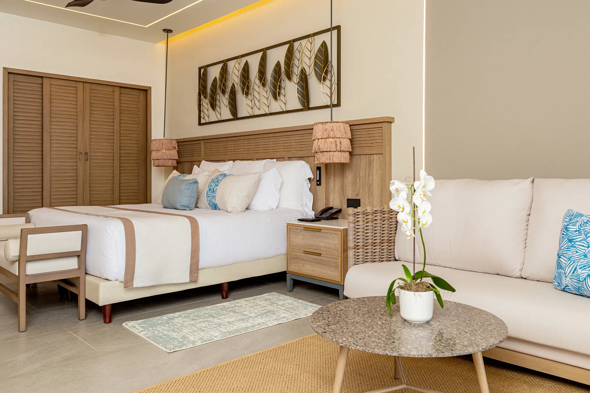 Preferred Club Junior Suite Partial Ocean with king bed and seating area at Secrets Tides Punta Cana resort.