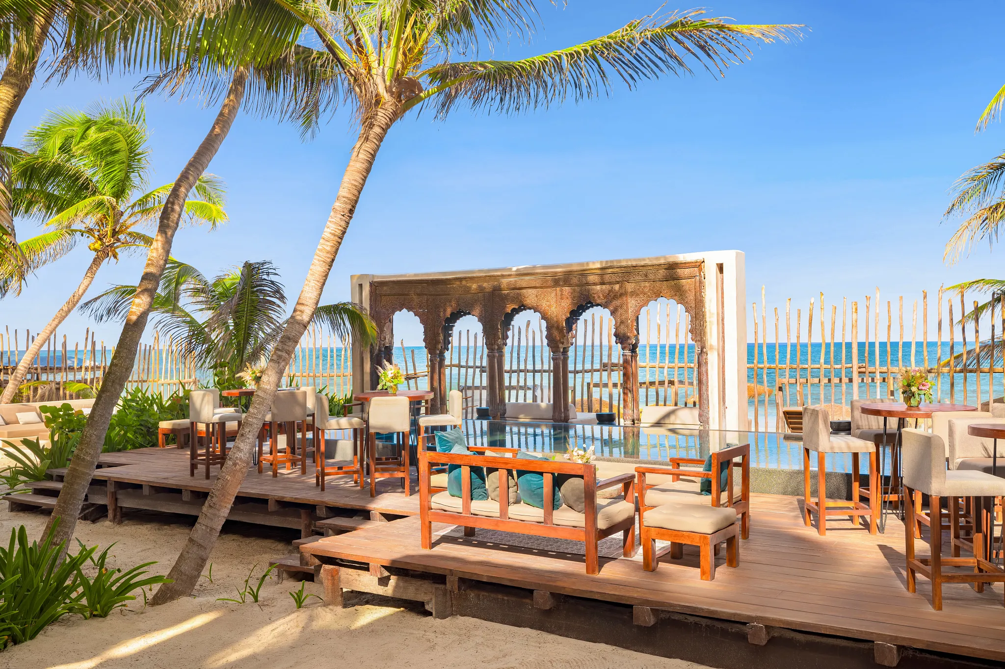 Elegant beachfront pool and lounge area at Casa Zamna Beach Club, part of Secrets Tulum Resort & Beach Club.