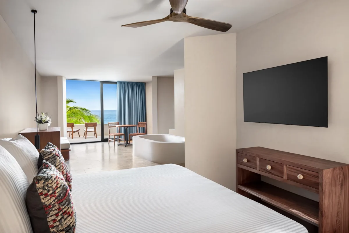 Casa Zamna Ocean Front Junior Suite king bedroom with soaking tub and ocean-view terrace at Secrets Tulum Resort & Beach Club.