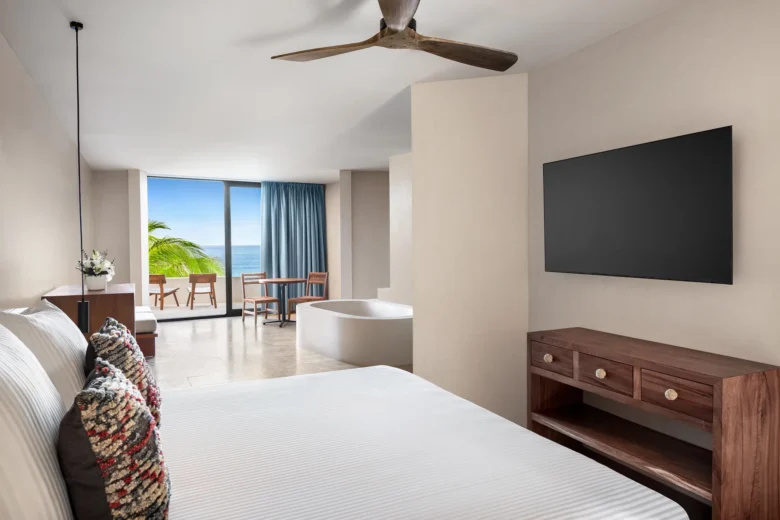 Casa Zamna Ocean Front Junior Suite king bedroom with soaking tub and ocean-view terrace at Secrets Tulum Resort & Beach Club.