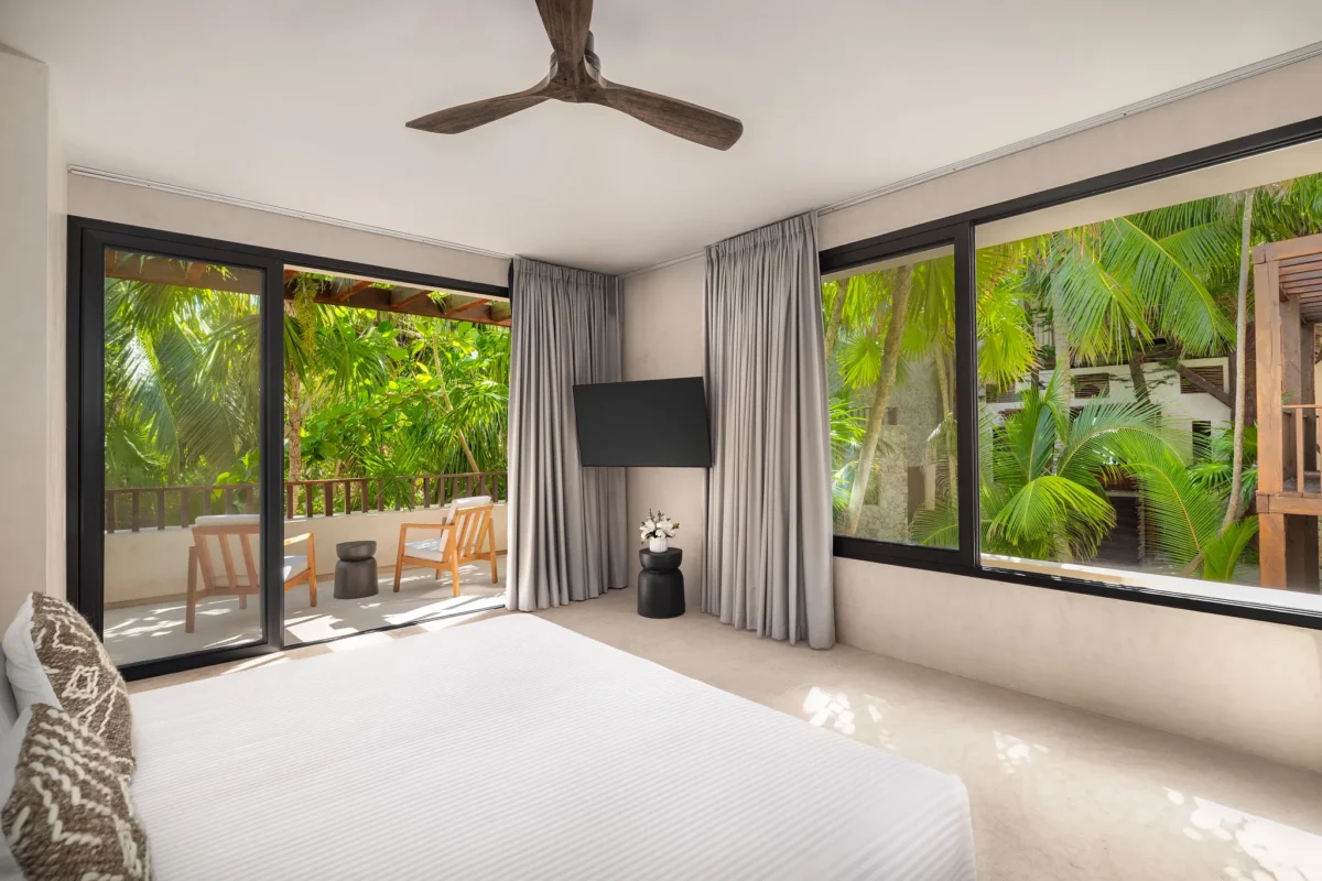Casa Zamna Tropical View king bedroom with furnished terrace at Secrets Tulum Resort & Beach Club.