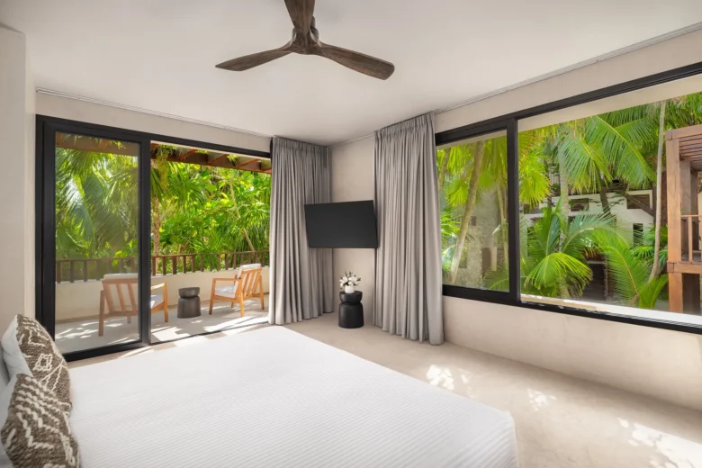 Casa Zamna Tropical View king bedroom with furnished terrace at Secrets Tulum Resort & Beach Club.