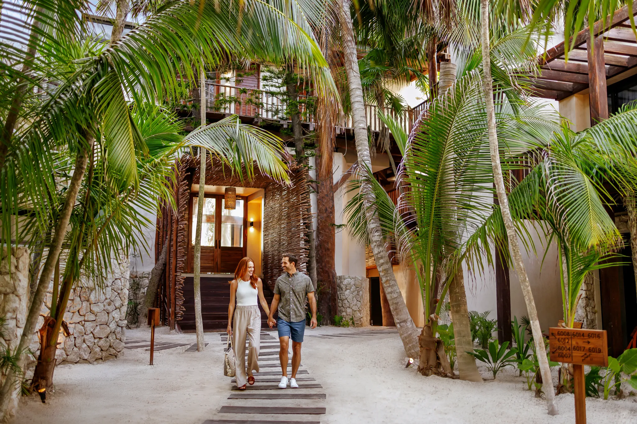 Couple strolling through tropical pathways at Secrets Tulum Resort & Beach Club.