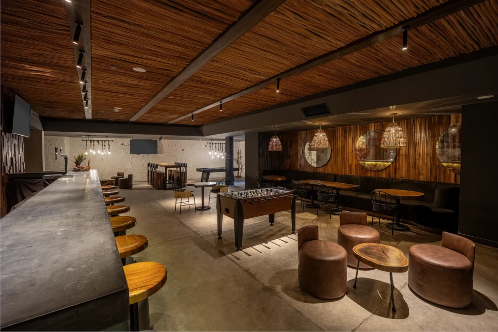 Half Time Sports Bar at Secrets Tulum Resort & Beach Club featuring big-screen TVs, premium drinks, casual seating, and a lively game-day atmosphere.