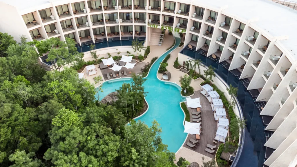 Aerial view of the lagoon-style pool and guest accommodations at Secrets Tulum Resort & Beach Club.