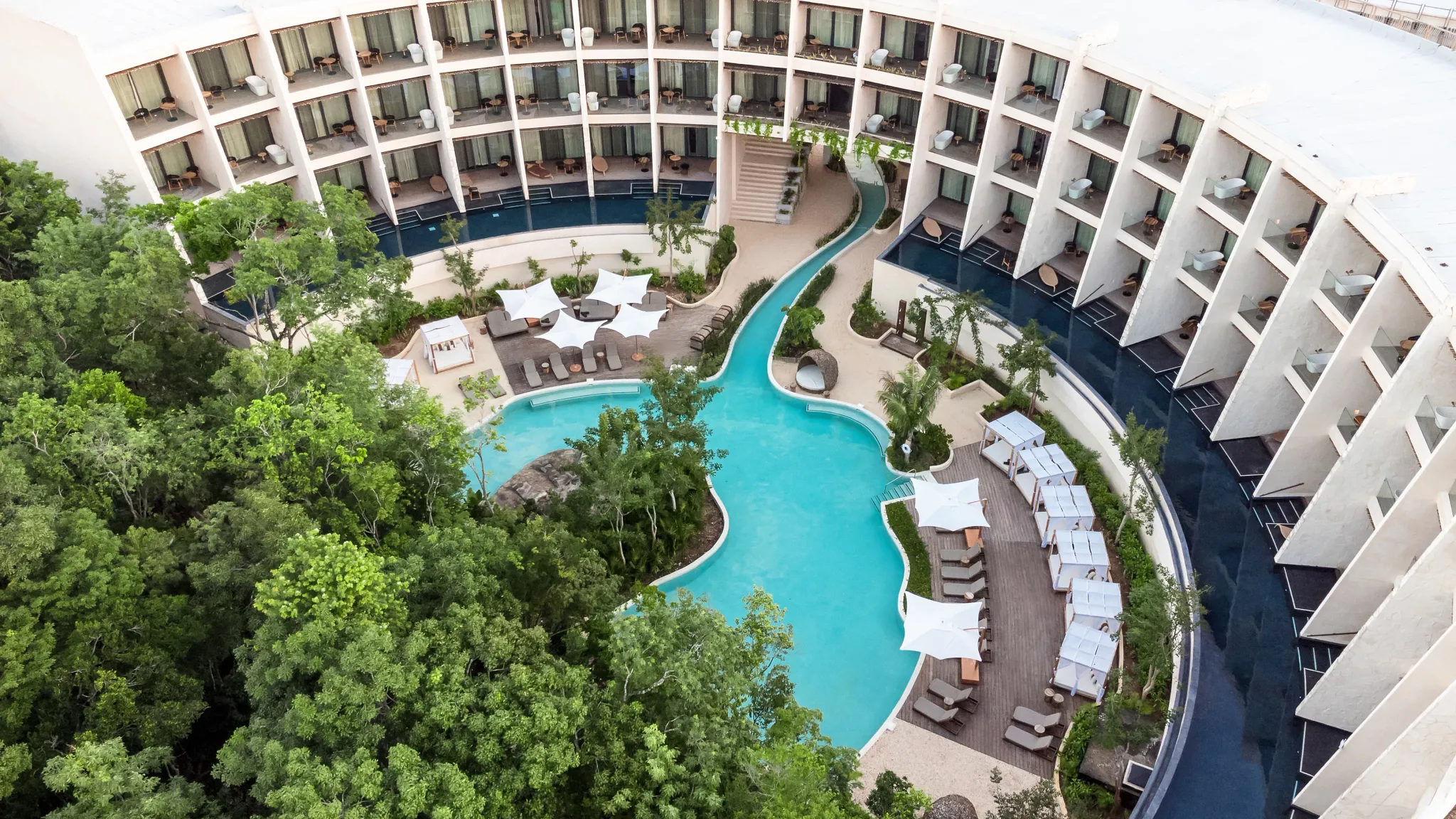 Aerial view of the lagoon-style pool and guest accommodations at Secrets Tulum Resort & Beach Club.